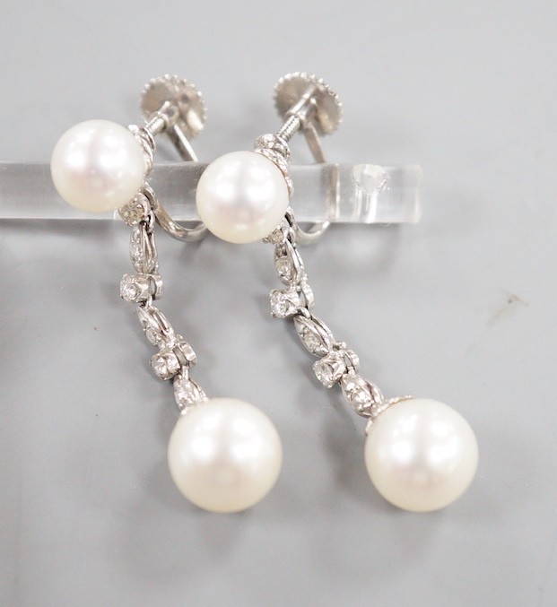 A modern pair of Maxim 14k white metal two stone cultured pearl and six stone diamond chip set line drop ear clips, 38mm, gross weight 6.3 grams.